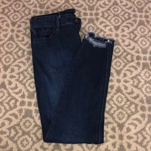 Dark wash raw hem skinny jean